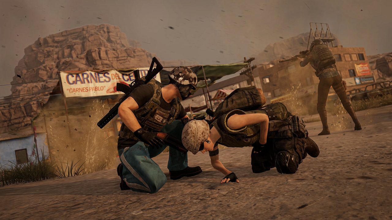 A player reviving a downed teammate on a dusty street beside a butcher shop sign while a squadmate fires a rifle at a distant enemy.